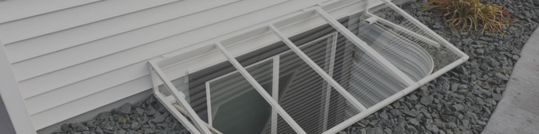 Aluminum frame window well covers from Custom Plastics.